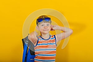 A boy with glasses and with fins preparing to go to sea