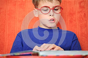 Boy reading a book intently photo