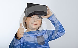 Boy with glasses of virtual reality, child tries new technology