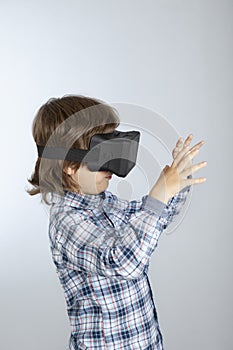 Boy with glasses of virtual reality, child tries new technology