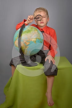 The boy with the globe and a magnifier.