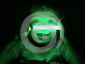 Smiling boy with glow stick photo