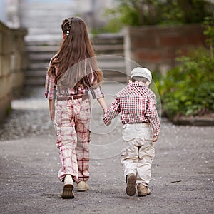 Boy go with his pretty sister for the walk