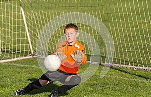 Boy goalkeeper defends