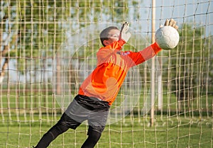 Boy goalkeeper defends