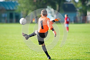 Boy - goalkeeper kicking soccer ball