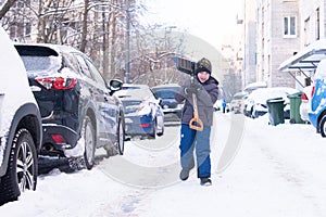 A boy goes to clean up snow in the courtyard of St. Petersburg