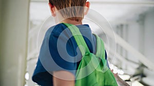 The boy goes under the bridge along a metal corridor. Cool footage. The camera is in motion. Atmospheric shots