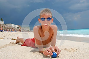 Boy with goggles on beach
