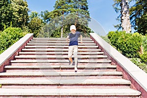 Boy going down on stairs barefoot