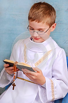 Boy going to the first holy communion with prayer book