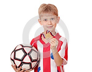 Boy with gold medal and ball