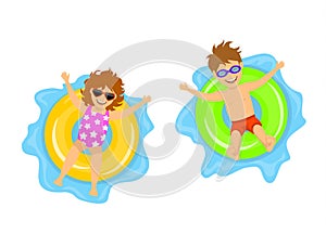 Boy and gorl swimming on inflatable inner rings,