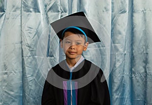 The boy graduated from kindergarten.
