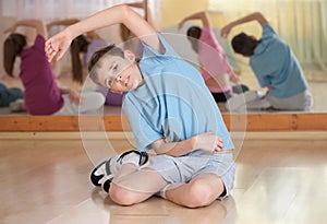 Boy and group engaged in physical training