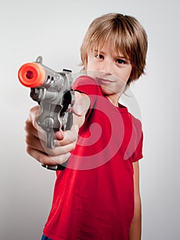 Boy with gun toy