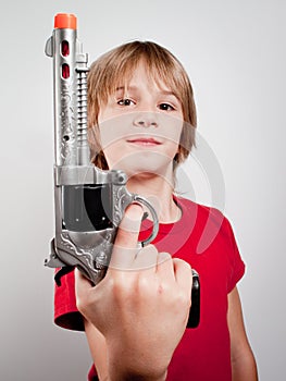 Boy with gun toy