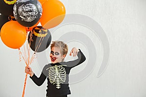 Boy with halloween balloons in orange and black color