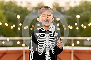 boy in halloween costume with ghost decoration