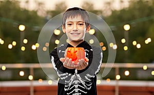 boy in halloween costume with jack-o-lantern