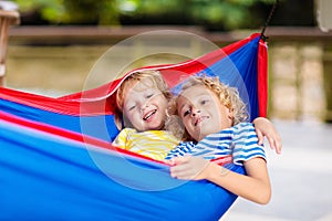 Boy in hammock. Kids play in summer garden