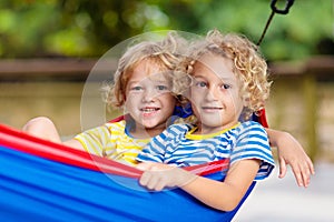 Boy in hammock. Kids play in summer garden