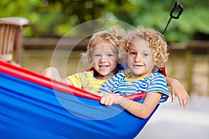 Boy in hammock. Kids play in summer garden