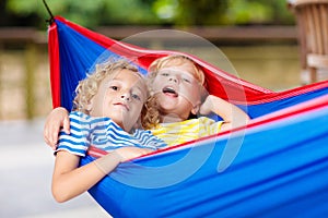 Boy in hammock. Kids play in summer garden