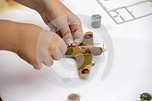 Boy hand applying waterslide decal to plastic model