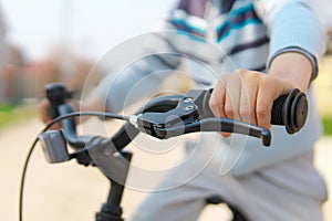 Boy hand on handlebar