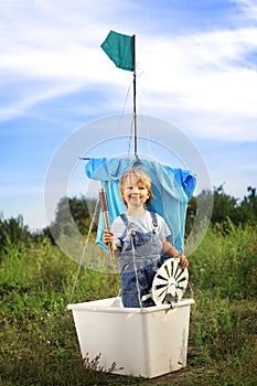 Boy in hand made ship outdoors play