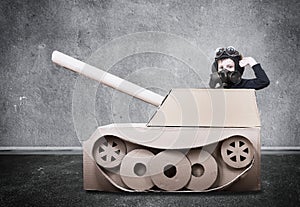 Boy in handmade cardboard panzer.