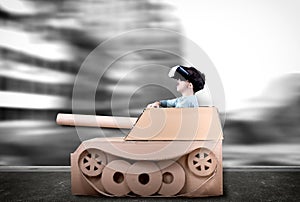 Boy in handmade cardboard panzer.