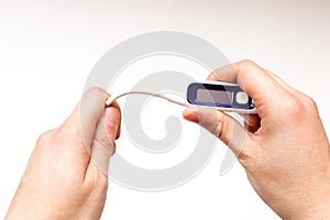 A boy hands holding a digital thermometer. Health care concept. Hands bend the thermometer. Bendable thermometer.