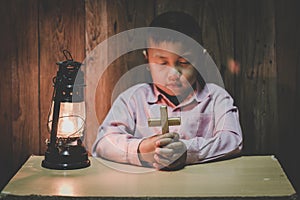 Boy hands holding a holy cross and praying to God, Child Praying for God Religion