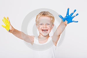 Boy with hands painted in colorful paints ready to make hand prints. School. Preschool. Education. Creativity. Studio portrait