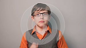 Boy hands to his mouth fright shock glasses ten