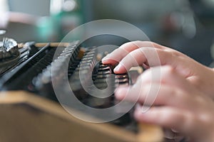 Boy hands writing on old typewriter