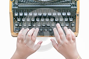 Boy hands writing on old typewriter isolated