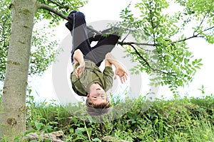 Boy hanging on the tree