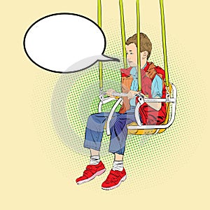 Boy has fun on the rides. Amusement park. Playground. Swinging on swing.