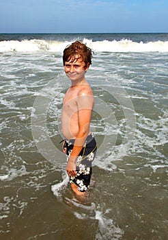 Boy has fun in the stormy beach