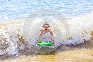 Boy has fun surfing in the waves