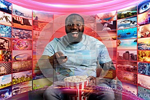 Boy has fun watching a film. Concept of entertainment and streaming tv. red background