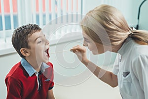 Boy has strep throat. Children`s ENT doctor examines boy`s throat. Children`s diseases, medical examination. medical test in