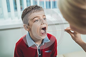 Boy has strep throat. Children`s ENT doctor examines boy`s throat. Children`s diseases, medical examination. medical test in