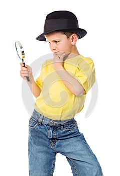 Boy in hat with magnifying glass
