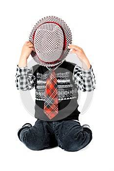 Boy with hat and tie studio shot isolated on a white background