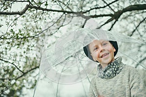 Boy in a hat with an umbrella