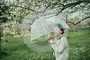 Boy in a hat with an umbrella